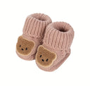 Knitted baby shoes with a teddy bear motif
